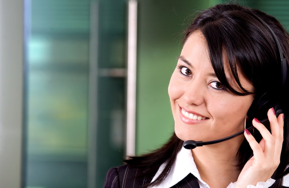 business customer support girl with a headset in an office